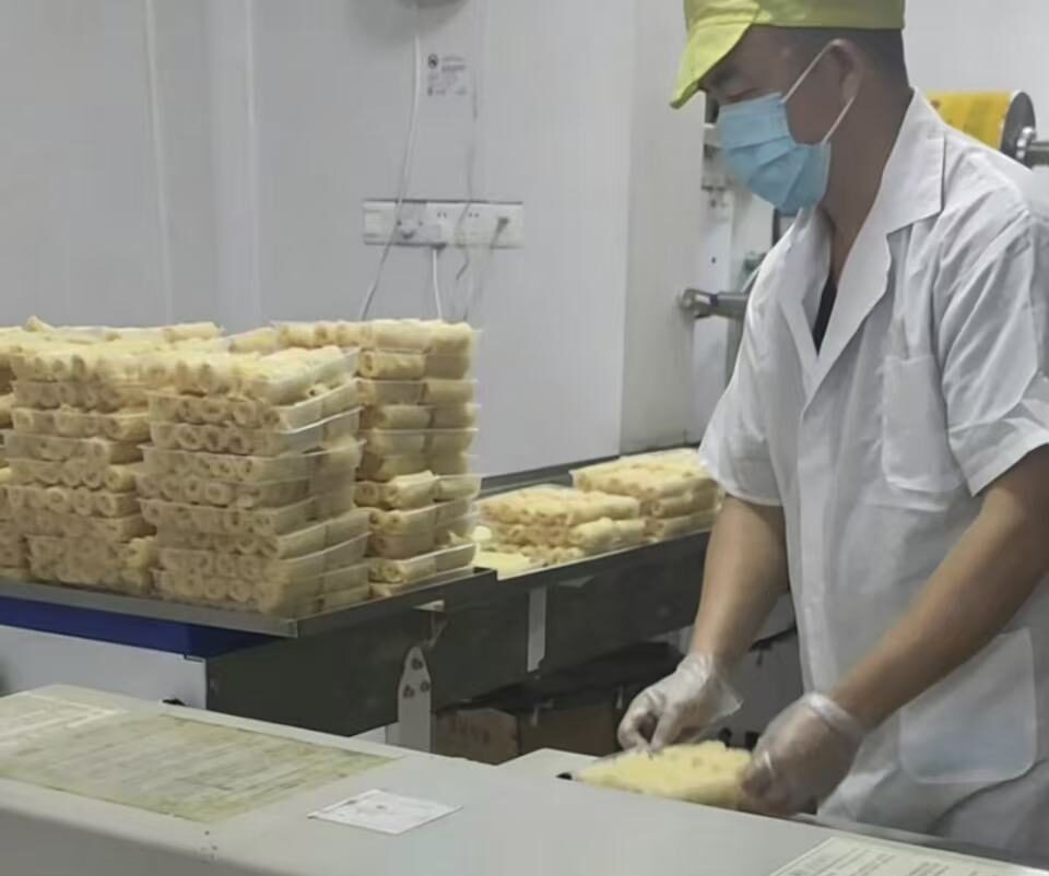Workers operating a soy food production line